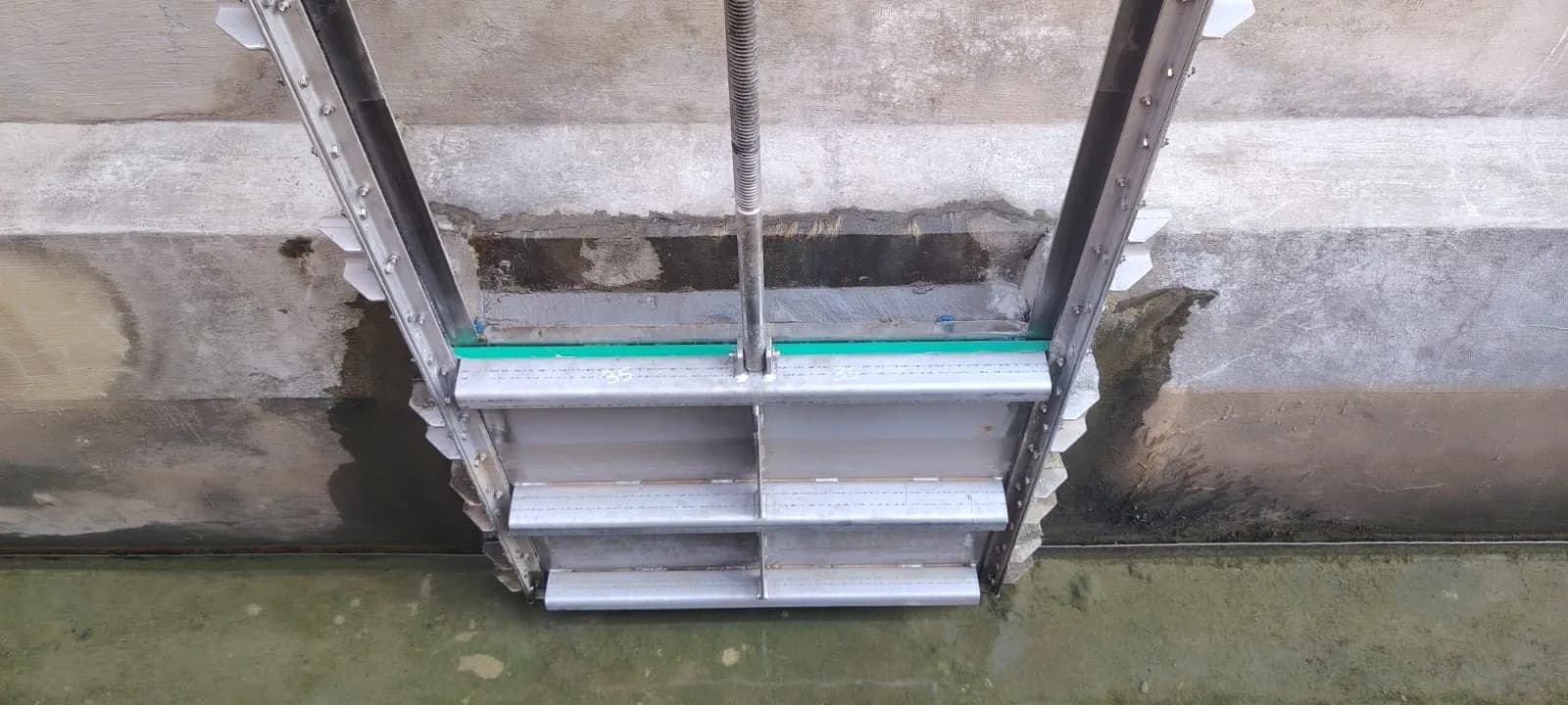 The new stainless sluice gate seated in its channel, seen from above